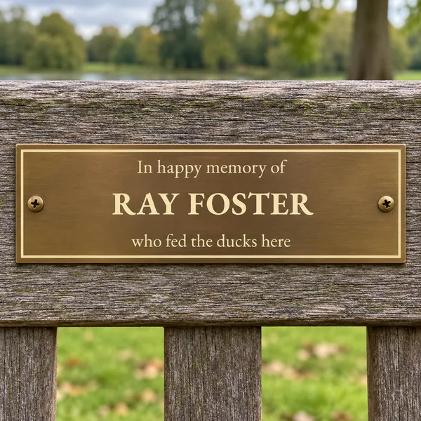 Personalised aged brass bench plaque 150 × 50 mm, shown with example wording