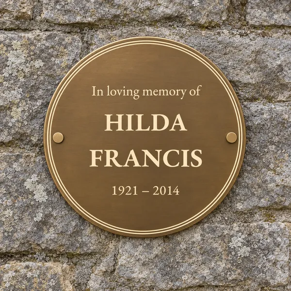Personalised aged brass circular plaque 200 × 200 mm, shown with example wording