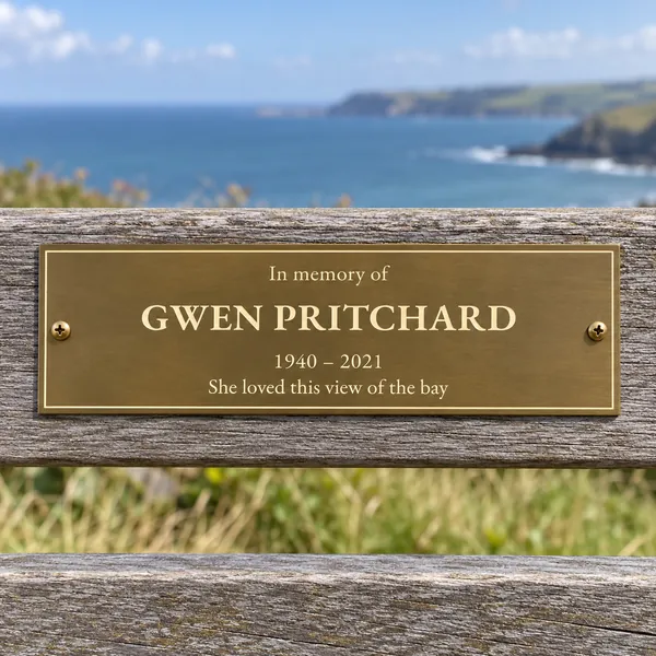 Personalised aged brass bench plaque 225 × 75 mm, shown with example wording