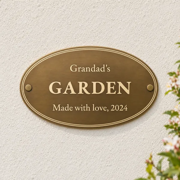 Personalised aged brass oval plaque 250 × 150 mm, shown with example wording