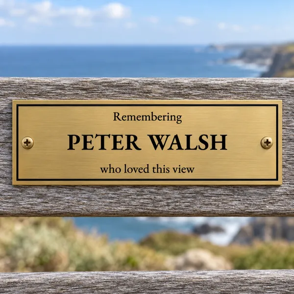 Personalised brushed brass bench plaque 150 × 50 mm, shown with example wording