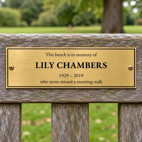 Personalised brushed brass bench plaque 225 × 75 mm, shown with example wording