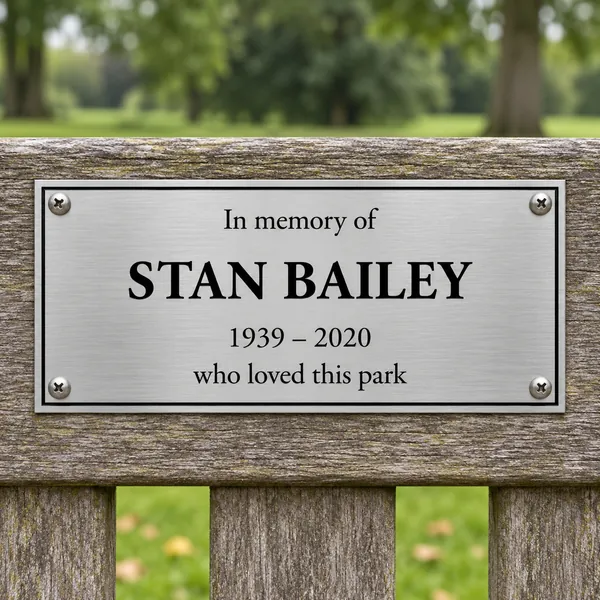 Personalised brushed stainless steel bench plaque 150 × 75 mm, shown with example wording