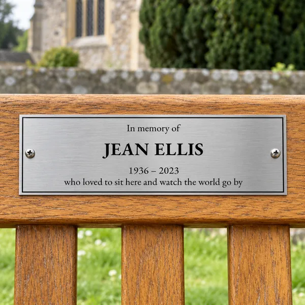 Personalised brushed stainless steel bench plaque 225 × 75 mm, shown with example wording