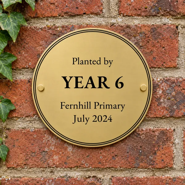 Personalised orbital brass circular plaque 200 × 200 mm, shown with example wording