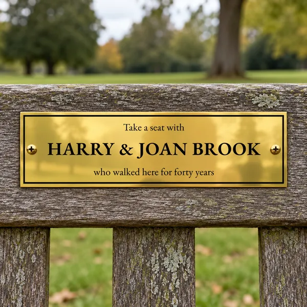 Personalised polished brass bench plaque 225 × 65 mm, shown with example wording
