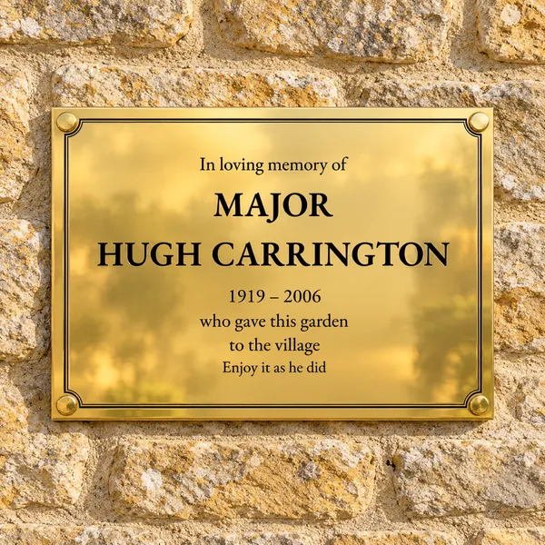 Personalised polished brass plaque 400 × 300 mm, shown with example wording