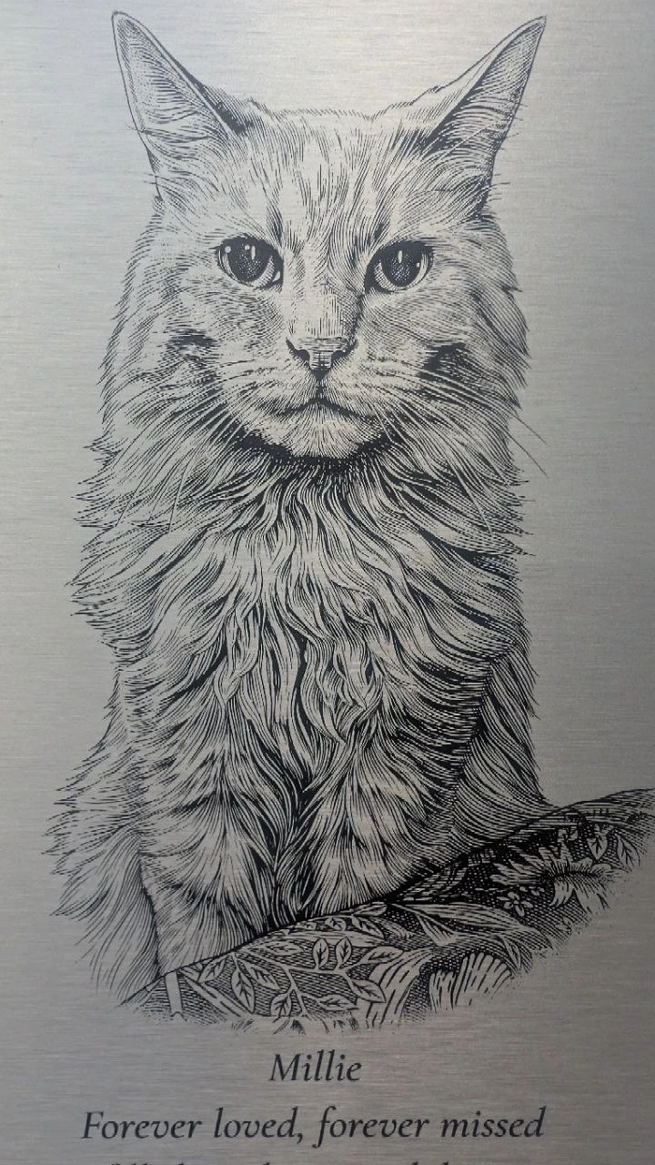 The same portrait engraved on Millie’s finished metal plaque, photographed